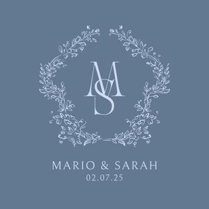 May include: A light blue wedding invitation featuring a floral wreath design. The initials "M" and "S" are in the centre of the wreath. The text "Mario & Sarah" and "02.07.25" are below the wreath.