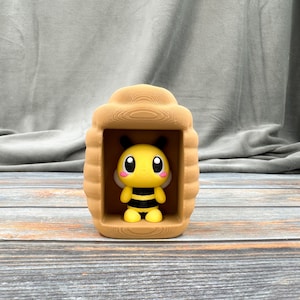 May include: A white ceramic mug with a black handle and the text "But First, Coffee" in a bold, black font. The mug is set against a blurred background, suggesting a cozy setting.