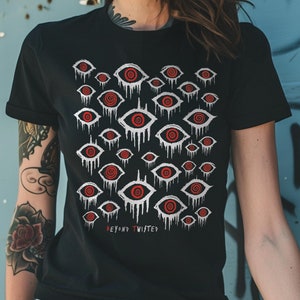 May include: Black t-shirt with a white and red eye pattern. The text "Beyond Twisted" is printed on the bottom of the shirt.