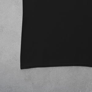 May include: A black t-shirt with a plain design. The shirt is made of a soft, comfortable fabric.