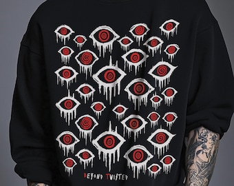 May include: A black crewneck sweatshirt featuring a repeating pattern of white eyes with red spiral irises. The eyes appear to be dripping downward. The text "BEYOND TWISTED" is printed in red at the bottom center of the graphic design.