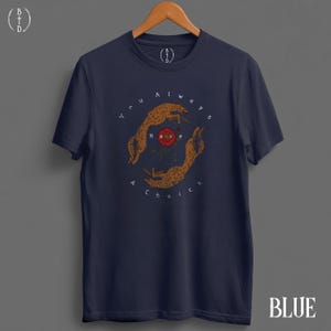 May include: Navy blue t-shirt with a circular graphic featuring two hands and a rose, with the text "You always have a choice." The shirt has a crew neck and short sleeves. The word "BLUE" is at the bottom right.