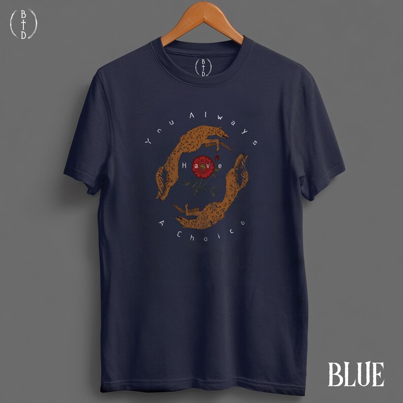 May include: Navy blue t-shirt with a circular graphic featuring two hands and a rose, with the text "You always have a choice." The shirt has a crew neck and short sleeves. The word "BLUE" is at the bottom right.