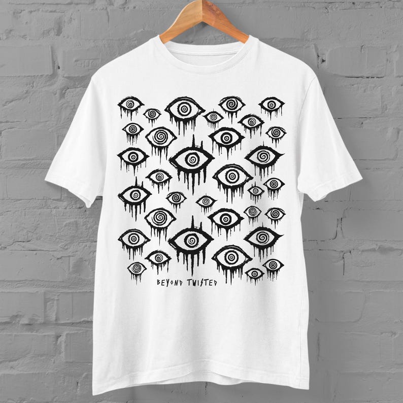 May include: White t-shirt featuring a black and white print of numerous eyes with spirals. The text "Beyond Twisted" is printed at the bottom of the shirt.