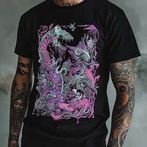 May include: A black short-sleeved t-shirt featuring a detailed graphic print of multiple skeletal dinosaur heads and abstract organic shapes in shades of vibrant pink, light blue, and white, arranged in a dense, layered composition.