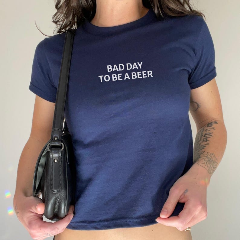 Bad Day to Be a Beer Baby Tee, Funny Drinking Shirt, 4th of July Outfit, USA Party Tee, Lake Day Shirt, Trendy Summer Graphic Tee, Baby Tee