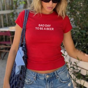 Bad Day to Be a Beer Baby Tee, Funny Drinking Shirt, 4th of July Outfit, USA Party Tee, Lake Day Shirt, Trendy Summer Graphic Tee, Baby Tee