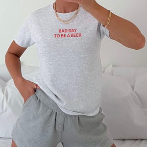 Bad Day to Be a Beer Baby Tee, Funny Drinking Shirt, 4th of July Outfit, USA Party Tee, Lake Day Shirt, Trendy Summer Graphic Tee, Baby Tee