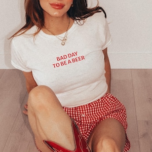 Bad Day to Be a Beer Baby Tee, Funny Drinking Shirt, 4th of July Outfit, USA Party Tee, Lake Day Shirt, Trendy Summer Graphic Tee, Baby Tee