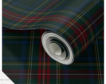 May include: A roll of wallpaper featuring a dark green, blue, and red tartan plaid pattern with thin white and yellow intersecting lines. The roll is partially unrolled, revealing a white interior core. Text includes Non Toxic, USA Sourced & Printed.