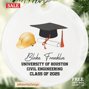 May include: White ceramic graduation ornament with a construction hard hat, graduation cap, and diploma design. The ornament includes the text "Blake Franklin, University of Houston, Civil Engineering, Class of 2025."
