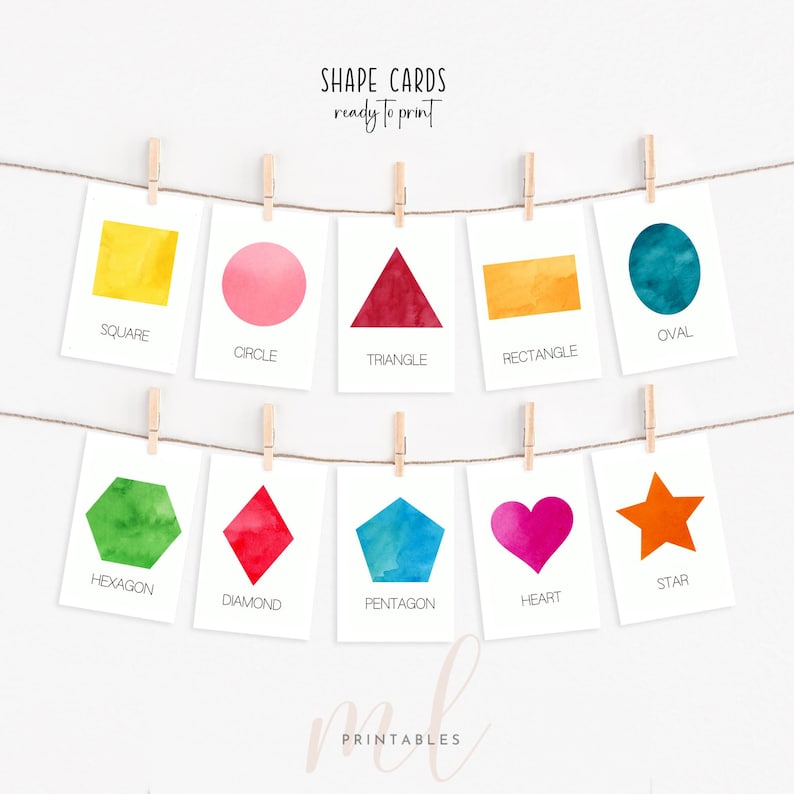 May include: Ten cards displaying various shapes in watercolour, including a square, circle, triangle, rectangle, oval, hexagon, diamond, pentagon, heart, and star. The cards are suspended from a string with pegs. Text on the cards reads "SHAPE CARDS ready to print".