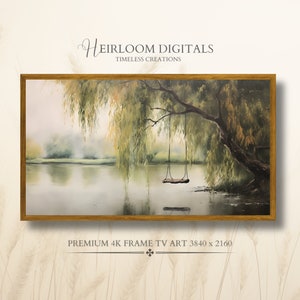 Puede incluir: Una pintura de acuarela enmarcada de un sauce llorón que cuelga sobre un lago con un columpio colgando de la rama. La pintura está en un marco de madera y tiene una paleta de colores apagados de verdes, marrones y azules.