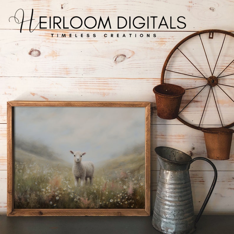 May include: A framed print featuring a lamb standing in a field of wildflowers. The artwork has a soft, muted color palette with a rustic wooden frame. The text "Heirloom Digitals - Timeless Creations" is at the top.