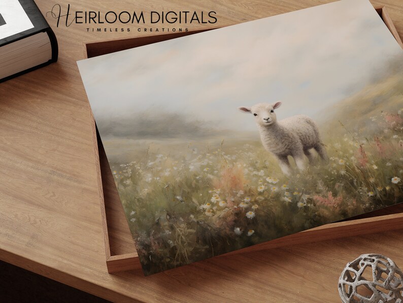 May include: A print featuring a lamb in a field of wildflowers. The lamb is white with a fluffy coat, standing in a meadow with daisies and tall grass. The print is in a wooden tray with the text "HEIRLOOM DIGITALS TIMLESS CREATIONS".