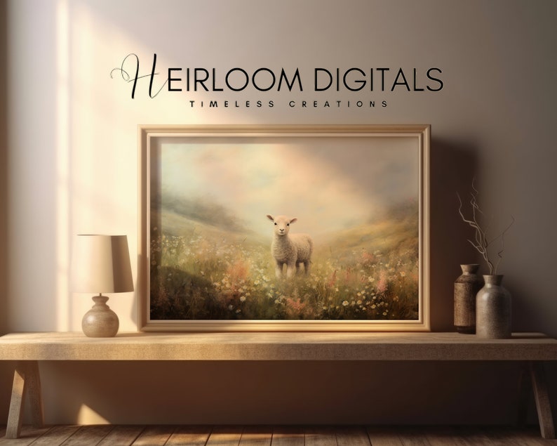 May include: A framed print featuring a lamb standing in a field of wildflowers under a soft, pastel sky. The artwork is displayed on a wooden table with a lamp and decorative vases. The text "Heirloom Digitals - Timeless Creations" is at the top.