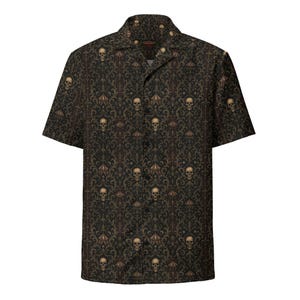 May include: A short-sleeve button-down shirt in a dark brown and black color palette. The fabric features a repeating damask-style pattern integrated with detailed human skull illustrations arranged in vertical columns across the entire garment.