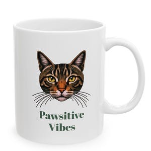 May include: White ceramic mug with a brown tabby cat illustration and the text "Pawsitive Vibes" in green.