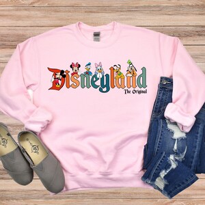 a pink sweatshirt with the words disneyland on it