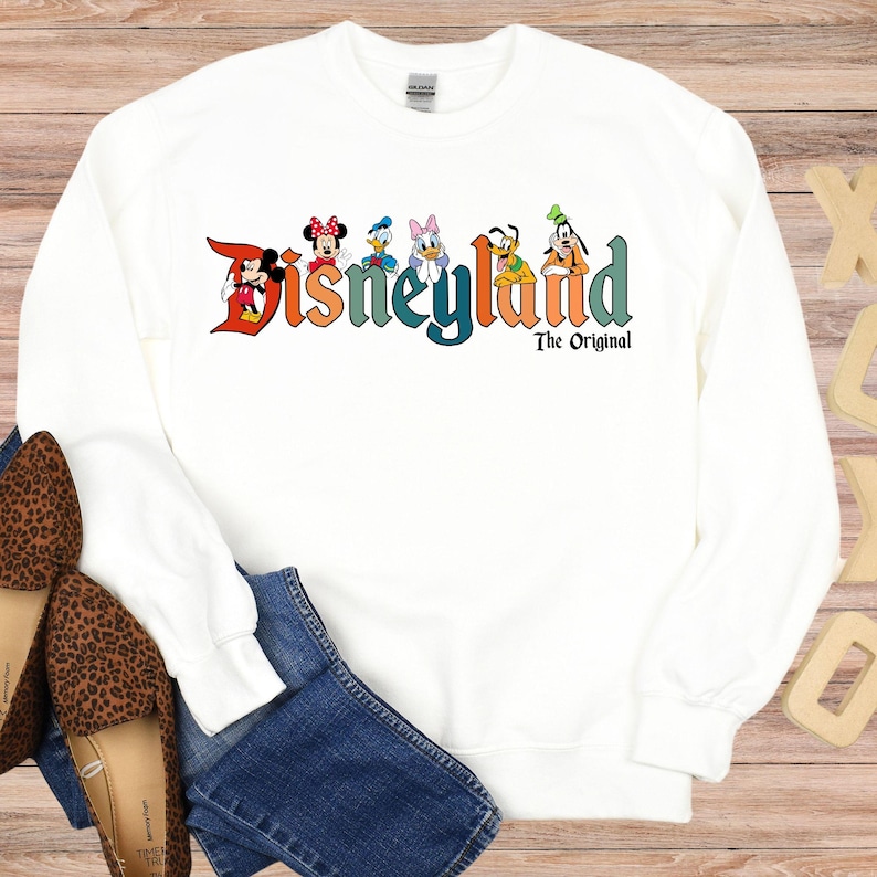 a white sweatshirt with the words disneyland on it