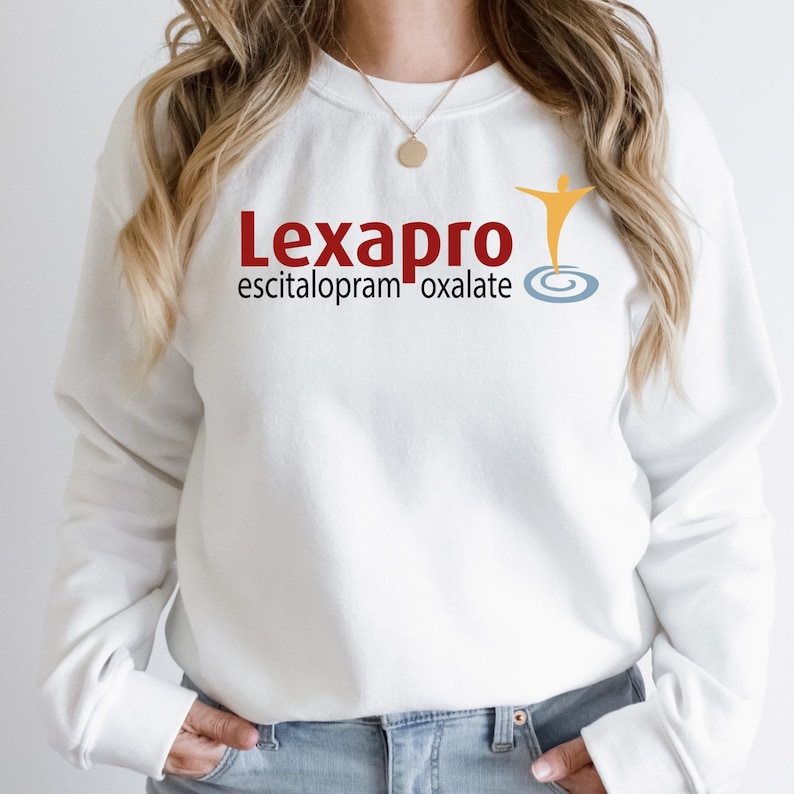 a woman wearing a white sweatshirt with a logo on it