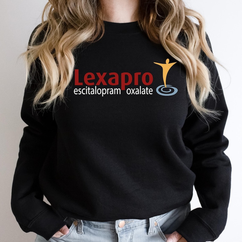 a woman wearing a black sweatshirt with a logo on it