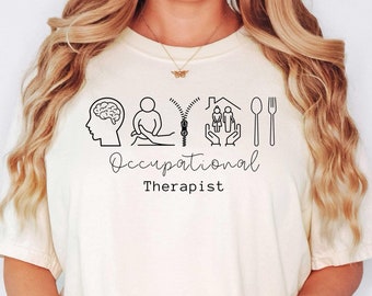 May include: A white t-shirt with black text and icons that reads "Occupational Therapist". The icons represent a brain, a person sitting, a zipper, a house, and a fork.
