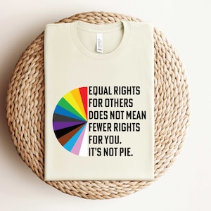 May include: A beige t-shirt with a graphic of a pie chart and the text "EQUAL RIGHTS FOR OTHERS DOES NOT MEAN FEWER RIGHTS FOR YOU. IT'S NOT PIE."