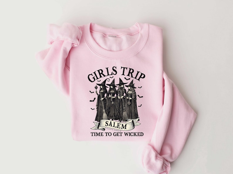 May include: Pink sweatshirt with a black graphic of four witches with the text "Girls Trip Salem Time to Get Wicked".