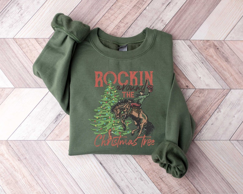 May include: A green sweatshirt with a Christmas tree design and the text "Rockin' around the Christmas Tree".