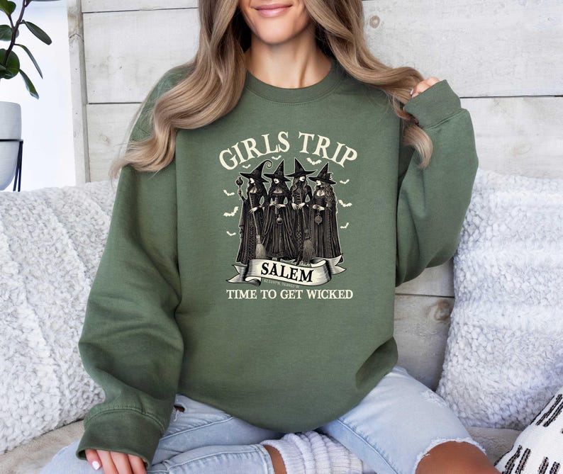 May include: Green sweatshirt with the text "Girls Trip Salem Time to Get Wicked" and a graphic of four witches with broomsticks.