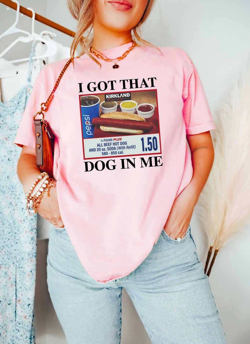 May include: Pink t-shirt with a graphic of a hot dog, soda, and condiments with the text "I got that dog in me" and "Kirkland" on it.
