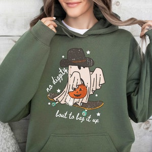 May include: Green hooded sweatshirt with a graphic of a ghost wearing a hat and holding a pumpkin. The ghost is skateboarding and the text "no diggity bout to bag it up" is printed below the ghost.