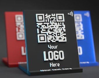 May include: Black stand with a white QR code, the text "Your LOGO Here" and a small blue wifi symbol. The stand is on a gray surface.