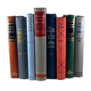 May include: A collection of vintage books with various colored spines. Titles include "Man of the Family," "Report from Pacific," "The Cross on the Drum," "Voice in the West," "The Autobiography of Bertrand Russell," "The Robe," "Ever After," and "The Web of Days."