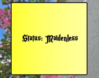 May include: A yellow square with the text "Status: Maidenless" in a gothic font. The background includes a blurred view of pink flowers, blue sky, and a light-colored wall.