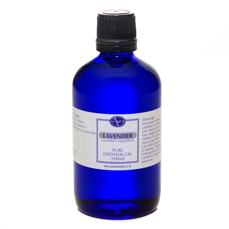 May include: A blue glass bottle with a black cap containing 100 ml of pure lavender essential oil. The label reads "Aura Lavender Lavandula Angustifolia Pure Essential Oil (100ml) www.aroessentialos.co.uk".
