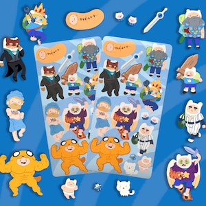 May include: A set of colorful cartoon character stickers featuring characters from the Adventure Time television show. The stickers are on a blue background and include characters like Finn, Jake, Princess Bubblegum, and Ice King.