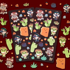 Op de afbeelding: Een set van twee sticker vellen met kleurrijke cartoon dier illustraties. De stickers zijn op een witte achtergrond en bevatten een verscheidenheid aan dieren, waaronder vossen, wasberen en cactussen. De stickers zijn perfect om een vleugje whimsy toe te voegen aan je planner, laptop of waterfles.