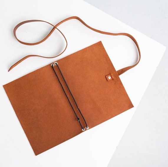 A genuine leather wrap cover that lets you swap in fresh notebook inserts — the journal that never ends.