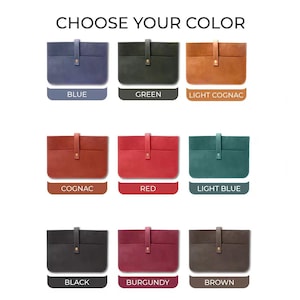 May include: Image showing nine different colored laptop sleeves. The colors include blue, green, light cognac, cognac, red, light blue, black, burgundy, and brown. Each sleeve has a flap closure with a button.