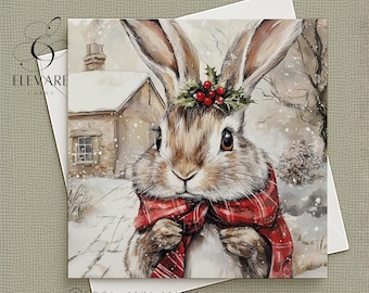 Pode incluir: Cartão de felicitações quadrado com uma ilustração em aquarela de um coelho em uma paisagem nevada. O coelho usa um cachecol xadrez vermelho e uma coroa de bagas de azevinho. Inclui o texto "©2024 ANN MARIA".