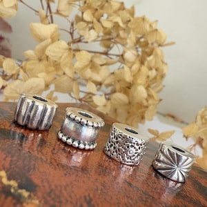 A Selection of Vintage Sterling Silver Retired Pandora Charms.