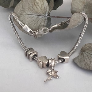Sterling Silver Foxtail Chain Bracelet with Four Charms. 8 Inches