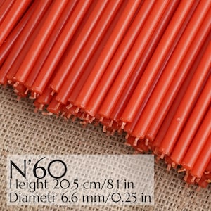 May include: A bundle of red taper candles. The candles are approximately 8.1 inches tall and 0.25 inches in diameter. The image includes the text "N'60".