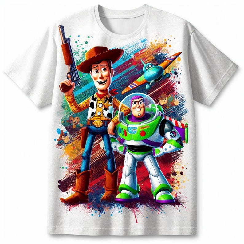 May include: White t-shirt featuring Woody and Buzz Lightyear from Toy Story. Woody is in a cowboy outfit holding a gun, and Buzz is in a spacesuit. The design includes a colourful splatter background and a toy aeroplane.