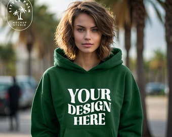 May include: A dark green hooded sweatshirt with the text "YOUR DESIGN HERE" printed in white on the front.