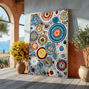 May include: A large, rectangular mosaic artwork featuring a vibrant array of colorful circles. The circles are composed of small, irregular tiles in shades of blue, yellow, red, and green. The artwork is framed in a light-colored wood and leans against a wall.