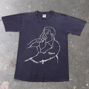 May include: A black short-sleeved t-shirt featuring a white line-art graphic of a person with a curly hairstyle eating food. The word Platinum is written in cursive script below the figure. The shirt has a crew neckline and a TND brand label.