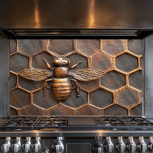 May include: A copper kitchen backsplash with a honeycomb pattern and a bronze bee sculpture in the centre.